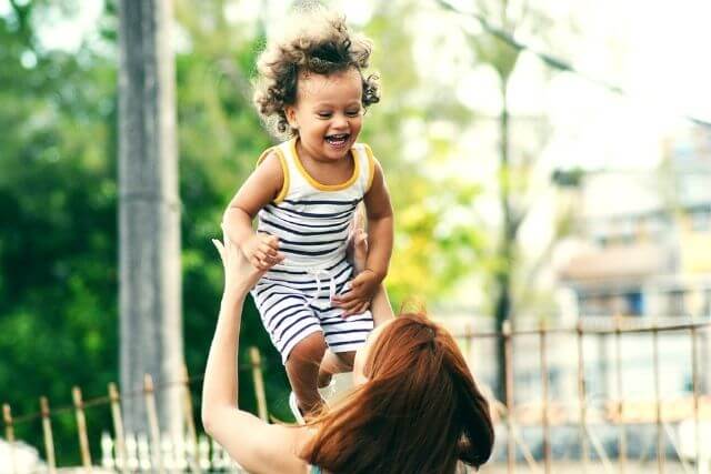 Small boy being lifted into air