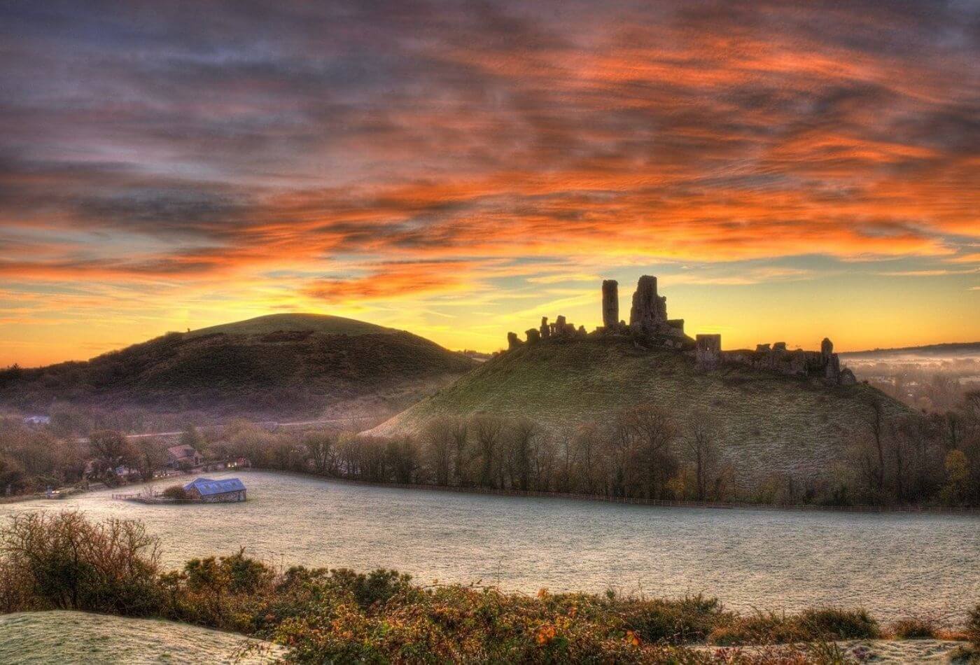 A scenic sunset over corfe castle, a popular dorset attraction