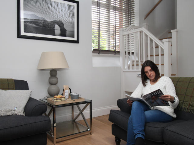 Lady reading on a sofa