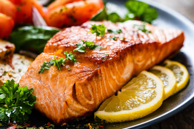 Salmon and vegetables on a plate in michelin star restaurant 