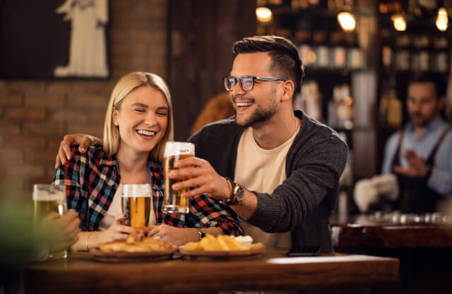 Young couple toasting beer